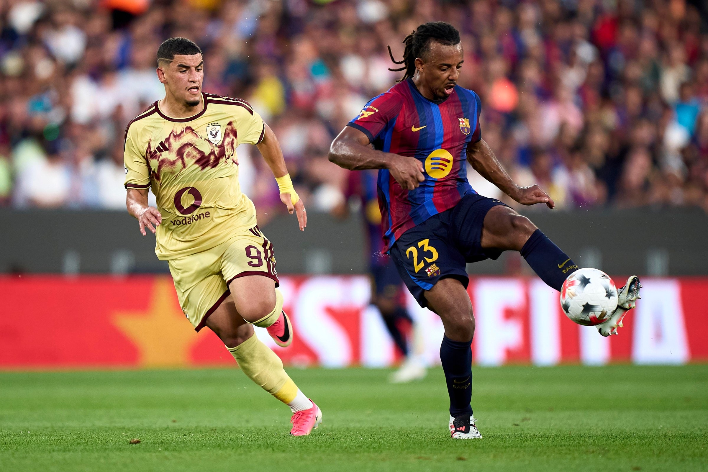 BARCELONA, SPAIN - AUGUST 19: Jules Kounde of FC Barcelona controls the ball under pressure from Soufiane Benjdida of Al Ahly SC during the Joan Gamper Trophy between FC Barcelona and Al Ahly SC at Spotify Camp Nou on August 19, 2026 in Barcelona, Spain. (Photo by Pablo Rodriguez/Quality Sport Images/Getty Images)