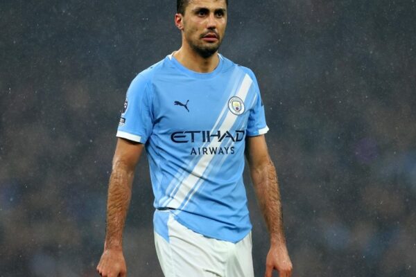Rodri avec le maillot de Manchester City sur un terrain de football.