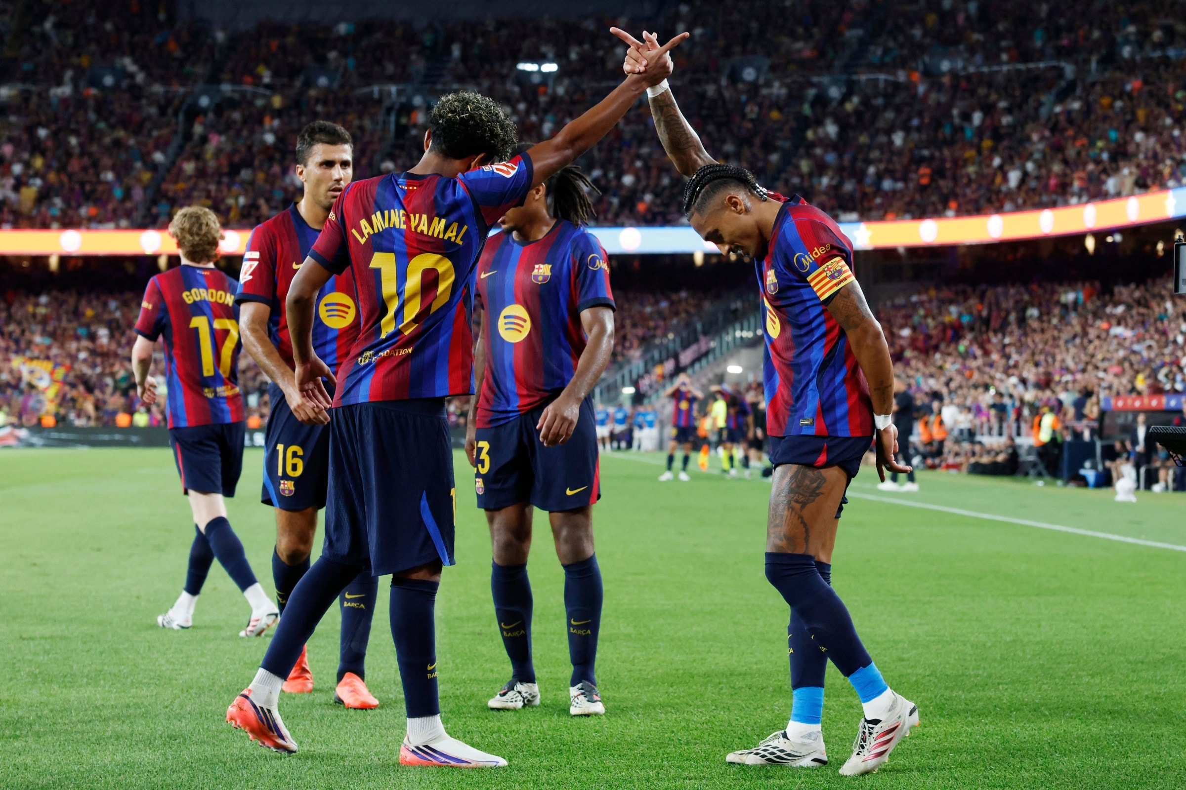 TOPSHOT - Barcelona’s Brazilian forward #11 Raphinha (R) celebrates scoring his team’s fourth goal with Barcelona’s Spanish forward #10 Lamine Yamal during the Spanish league football match between FC Barcelona and Rayo Vallecano de Madrid at Camp Nou Stadium in Barcelona on August 31, 2026. (Photo by Lluis GENE / AFP via Getty Images)