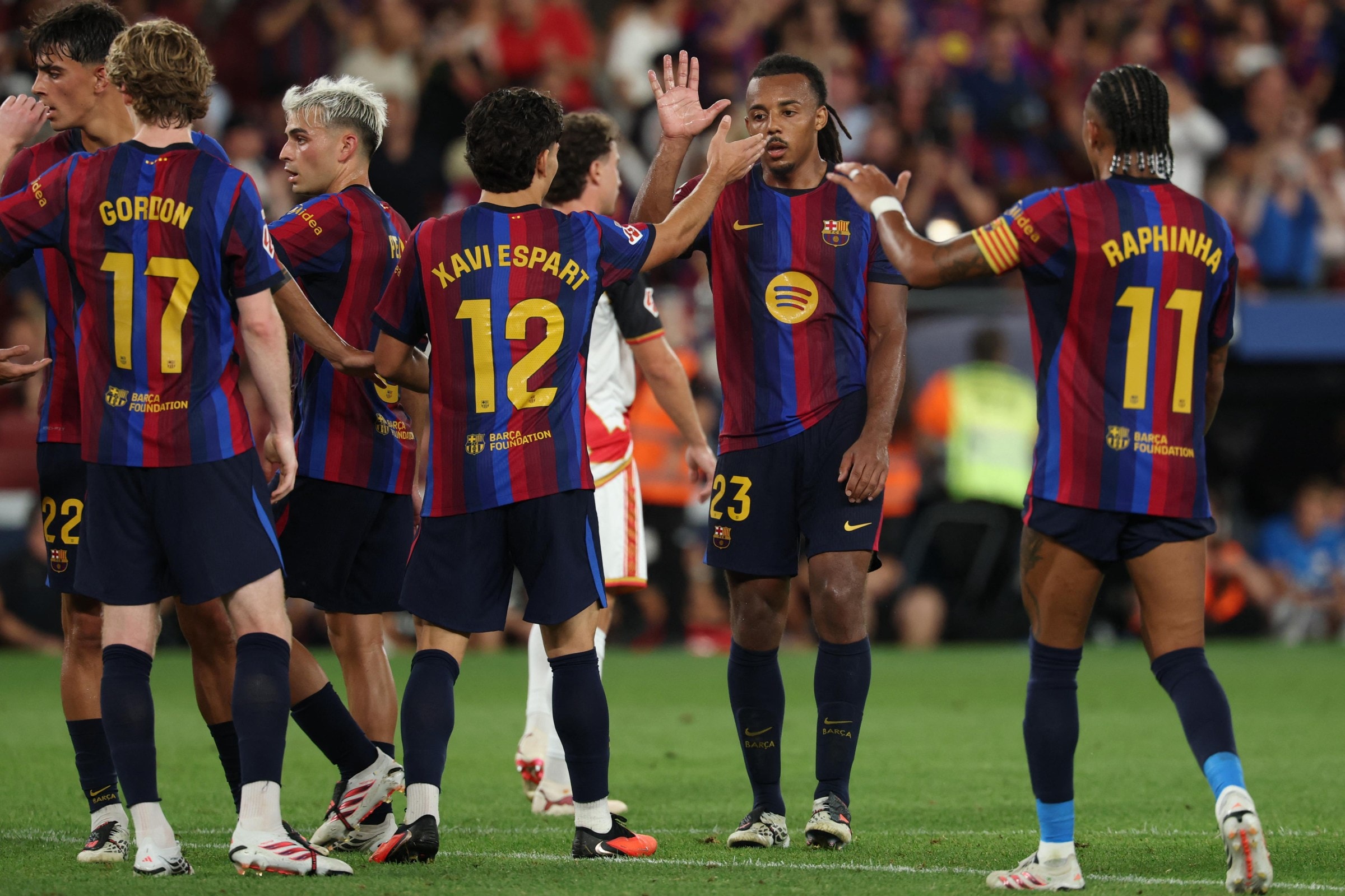 Barcelona’s French defender #23 Jules Kounde (2R) celebrates scoring his team’s third goal during the Spanish league football match between FC Barcelona and Rayo Vallecano de Madrid at Camp Nou Stadium in Barcelona on August 31, 2026. (Photo by Lluis GENE / AFP via Getty Images)