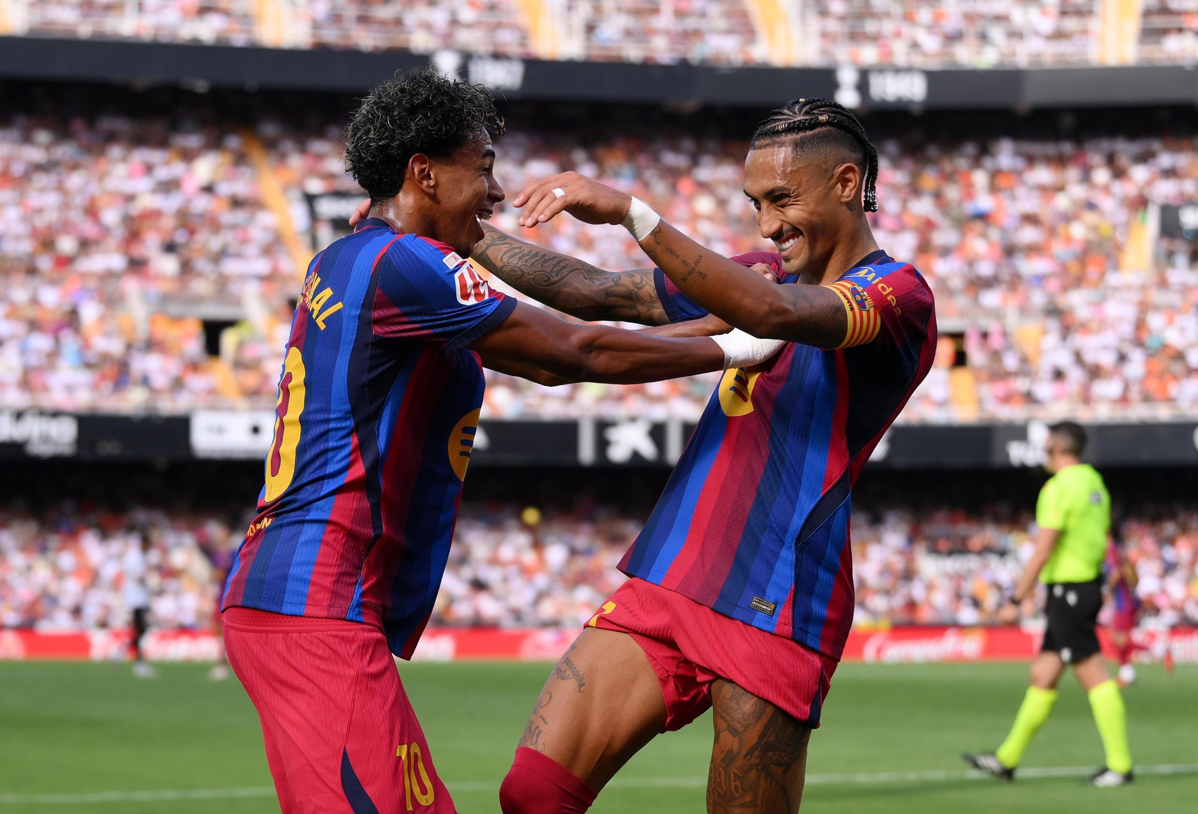 VALENCIA, SPAIN - SEPTEMBER 06: Raphinha of Barcelona celebrates scoring his team’s third goal with teammate Lamine Yamal during the LaLiga EA Sports 2026/27 match between Valencia CF and FC Barcelona at Estadi de Mestalla on September 06, 2026 in Valencia, Spain. (Photo by David Ramos/Getty Images)